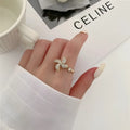 Micro rotating ring with spinning windmill centrepiece in gold or silver finish