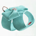 A pink microfiber dog chest strap with a large decorative bowknot, shown alongside blue and orange colour options.