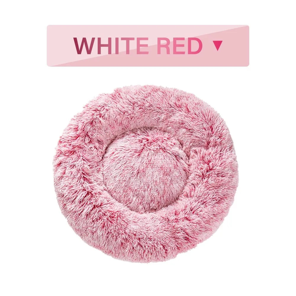 Fluffy donut-shaped pet bed in long plush fabric, shown in a light grey colour.