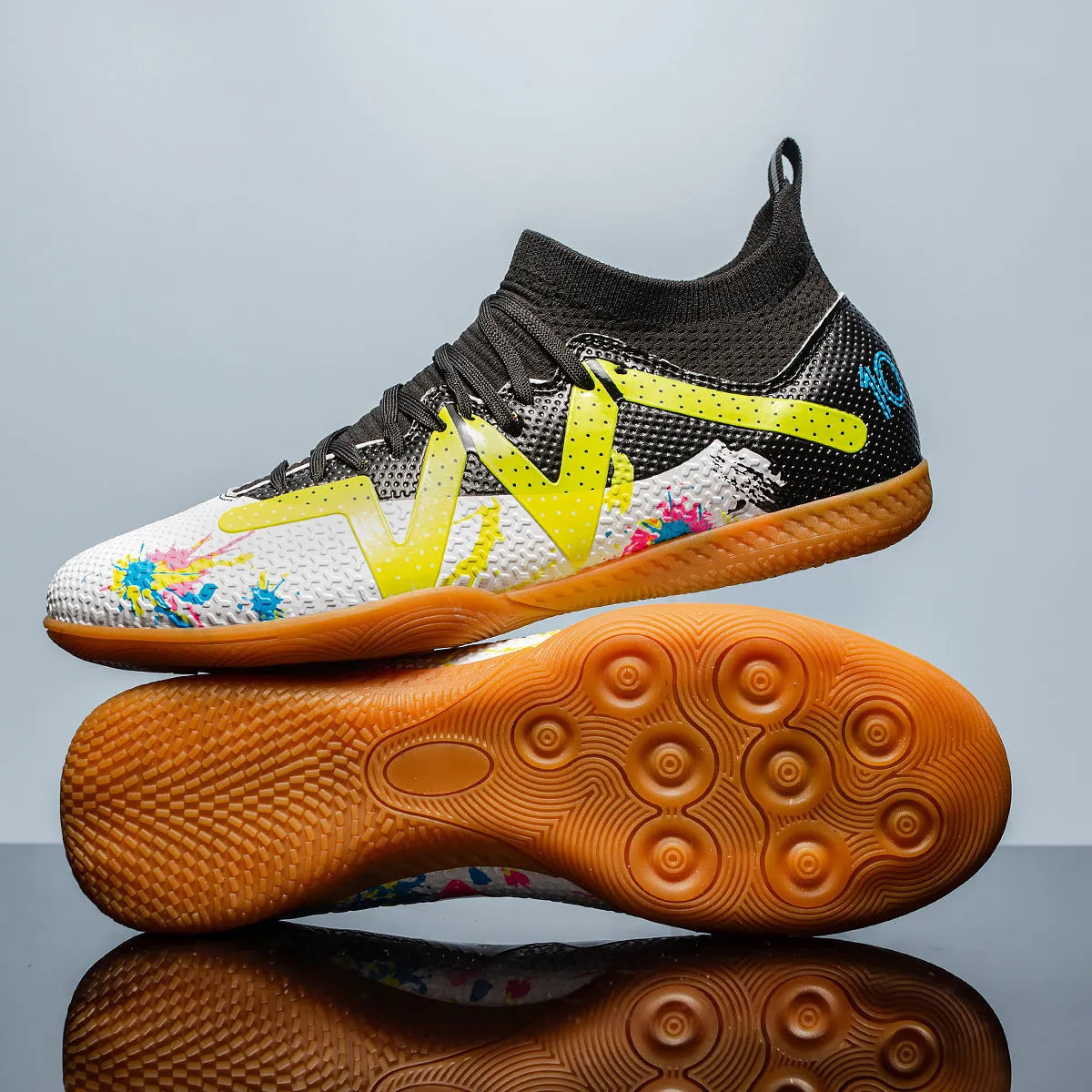 Adult football boots with replaceable studs in black and yellow colour with low-top mesh design