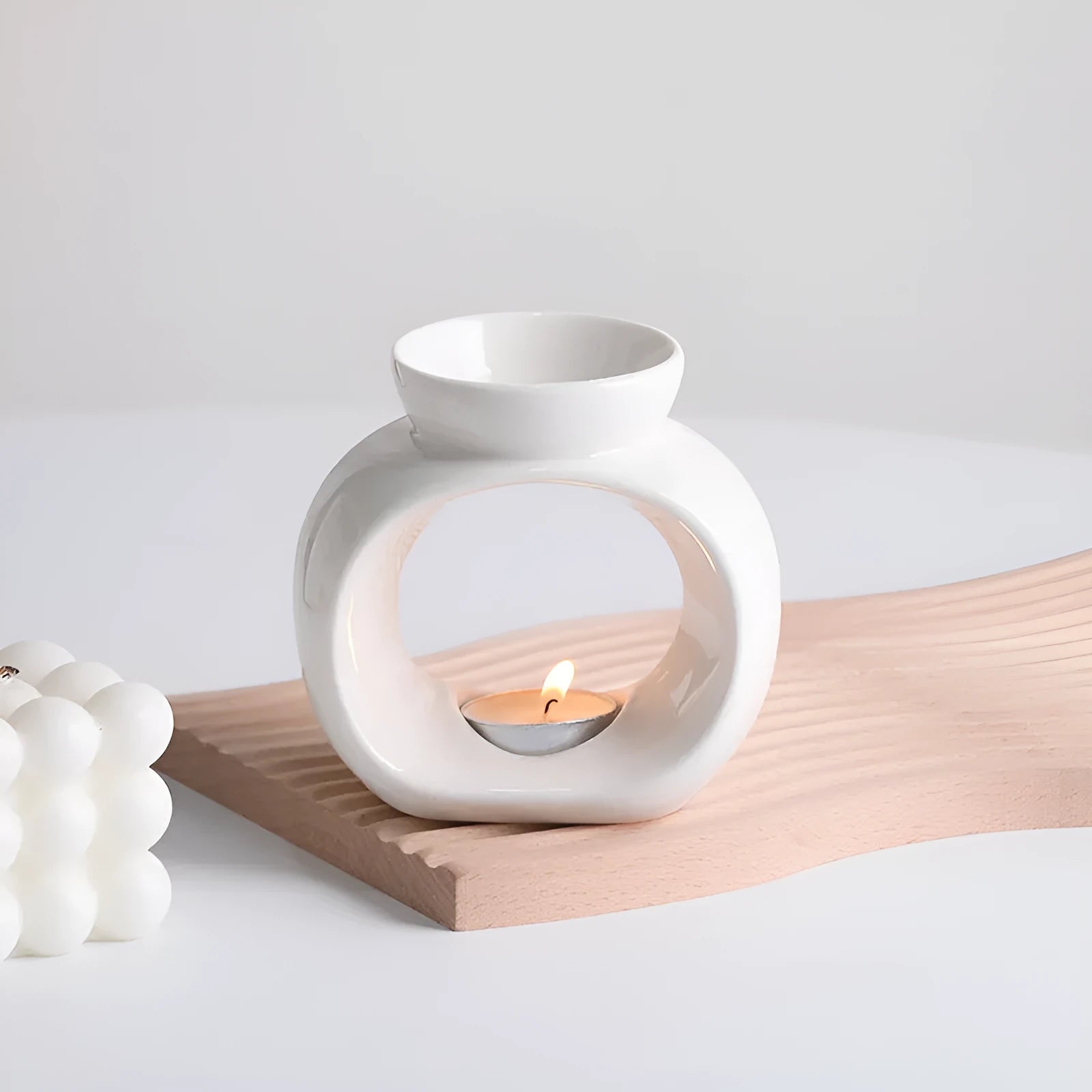 White ceramic Nordic style aromatherapy stove ornament measuring 10cm diameter