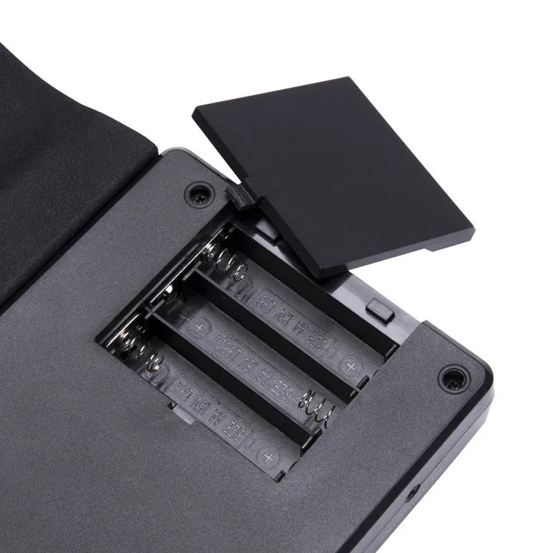 49 key roll up electronic keyboard in glossy black showing flexible silicone piano keys and portable folding design