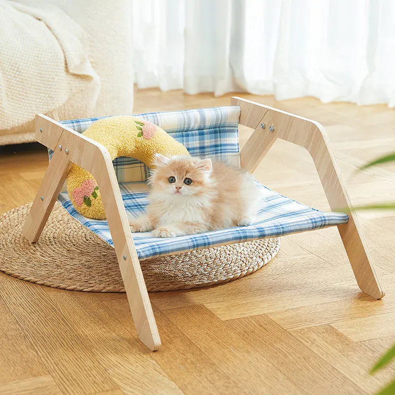 Wooden elevated cat bed with blue cloth cushion for indoor cats