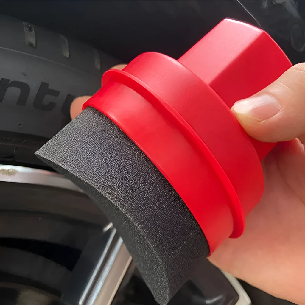 Black and red tyre polishing sponge brushes with lids on a surface, showing hand-held design and sponge options.