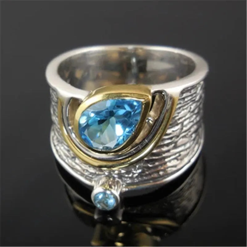 Close-up of a women's blue zircon alloy ring with Chinese style drop shape design and rhinestone inlay.