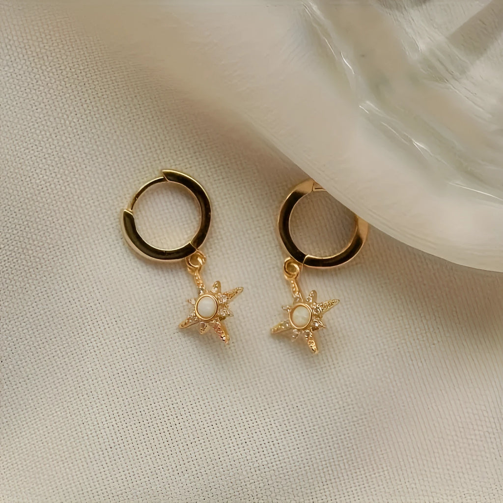 Gold copper eight-pointed star opal stud earrings on a white background