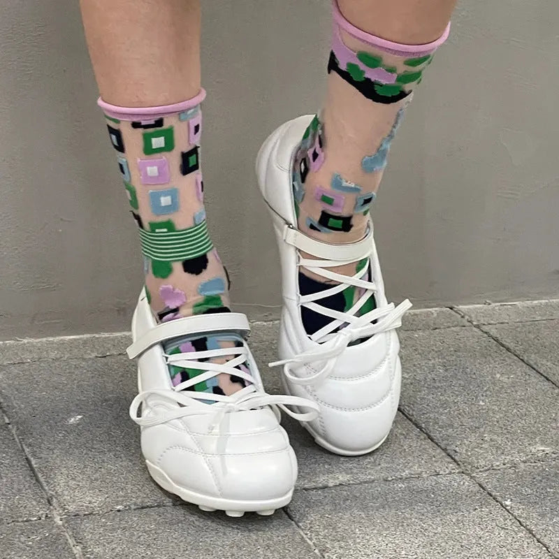 Women's silver lace-up sports shoes with a bow detail and round toe on a mid heel.
