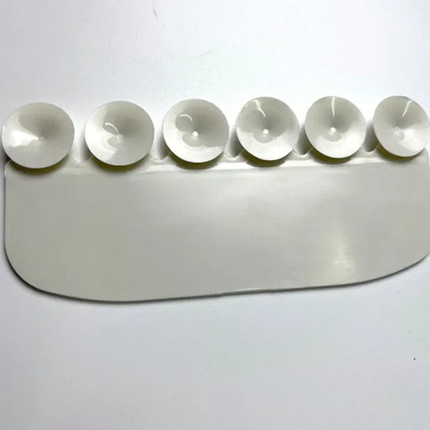 White plastic toilet urine guard for children's toilet training placed on standard toilet seat