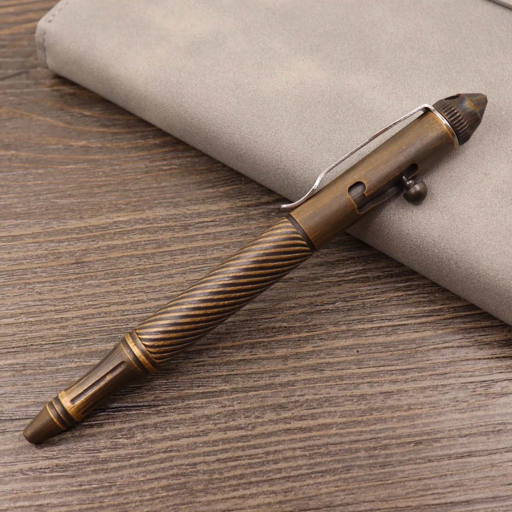 Retro brass tactical pen with press bolt-action mechanism and cylindrical metal barrel