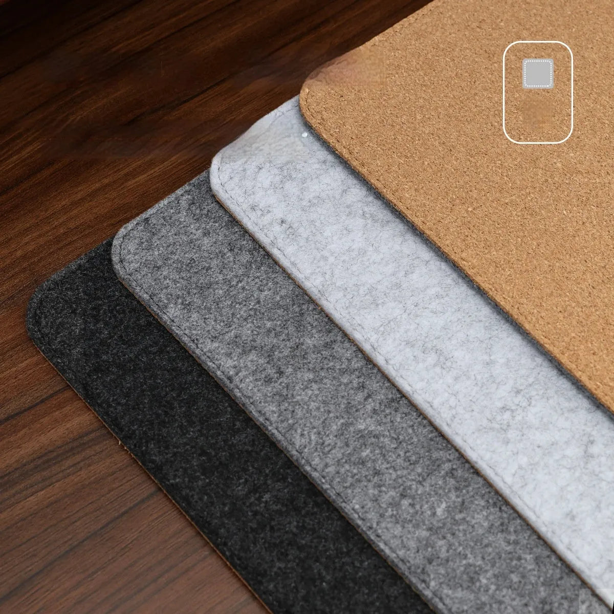 Oversized grey felt and cork desk mouse mat shown on a wooden desk with keyboard and mouse.