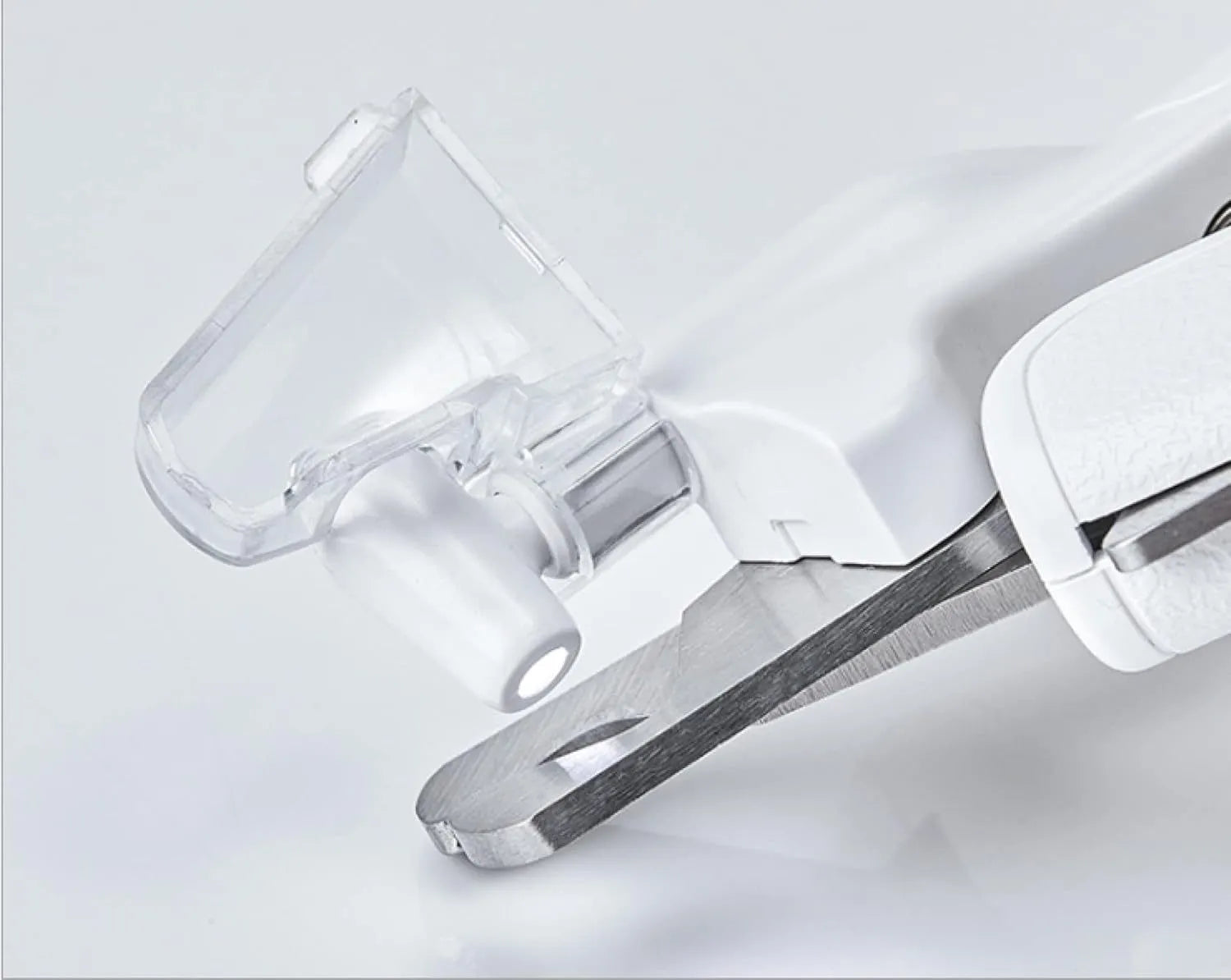 White pet nail clippers with LED light, transparent anti-splash baffle, and triangular steel blades for cats and dogs