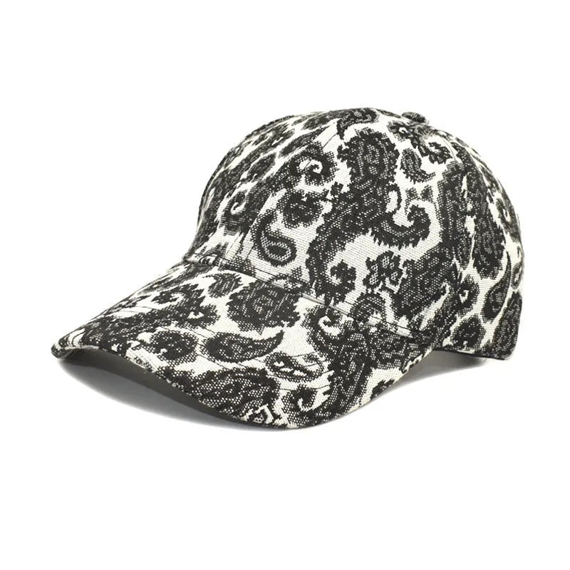 Blue polyester baseball cap with a white paisley pattern, showing the dome crown style.