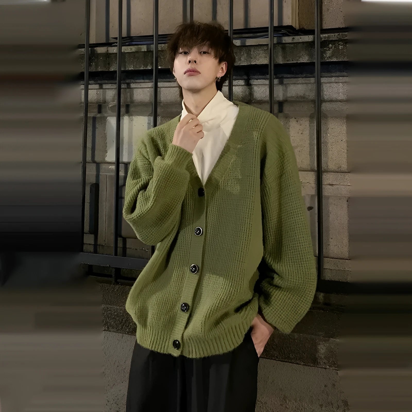 Men's loose fit V-neck knitted cardigan sweater in a solid colour on a hanger.