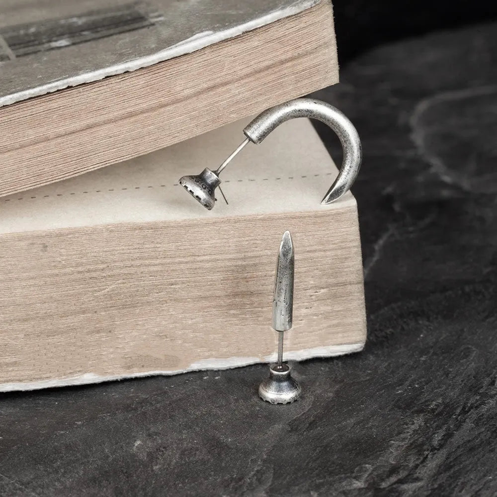 S925 sterling silver nail-shaped stud earrings on a plain background, showing straight and curved style options.