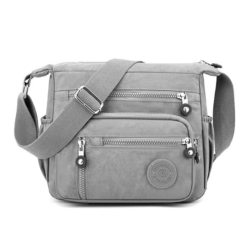 Soft nylon messenger bag with single shoulder strap in square vertical design showing grey colour option