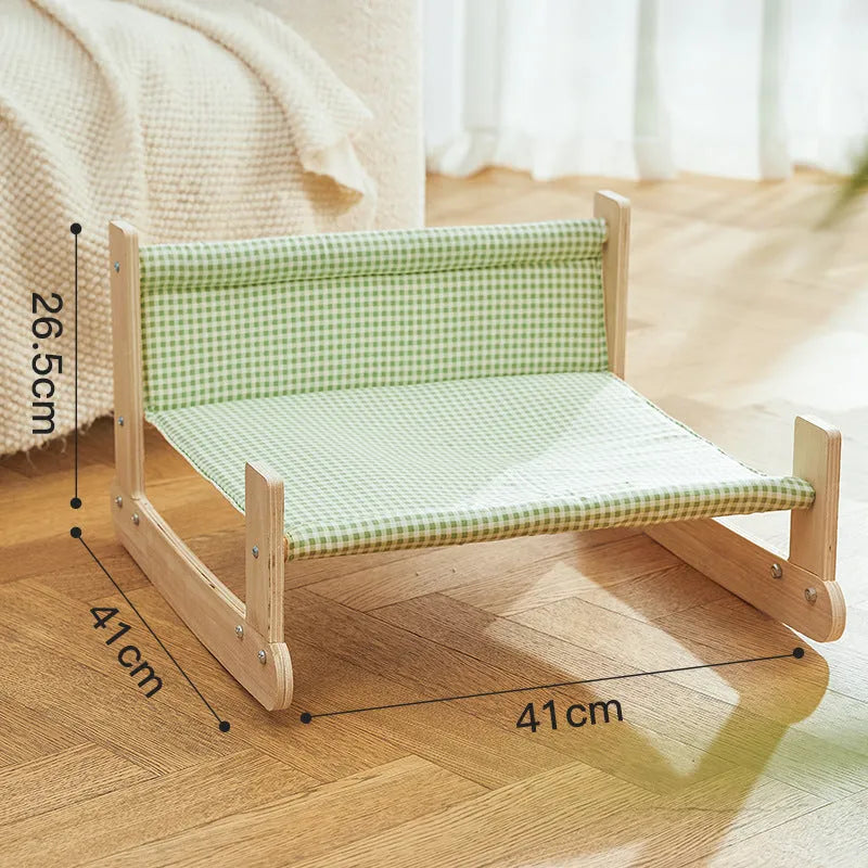 Wooden elevated cat bed with blue cloth cushion for indoor cats