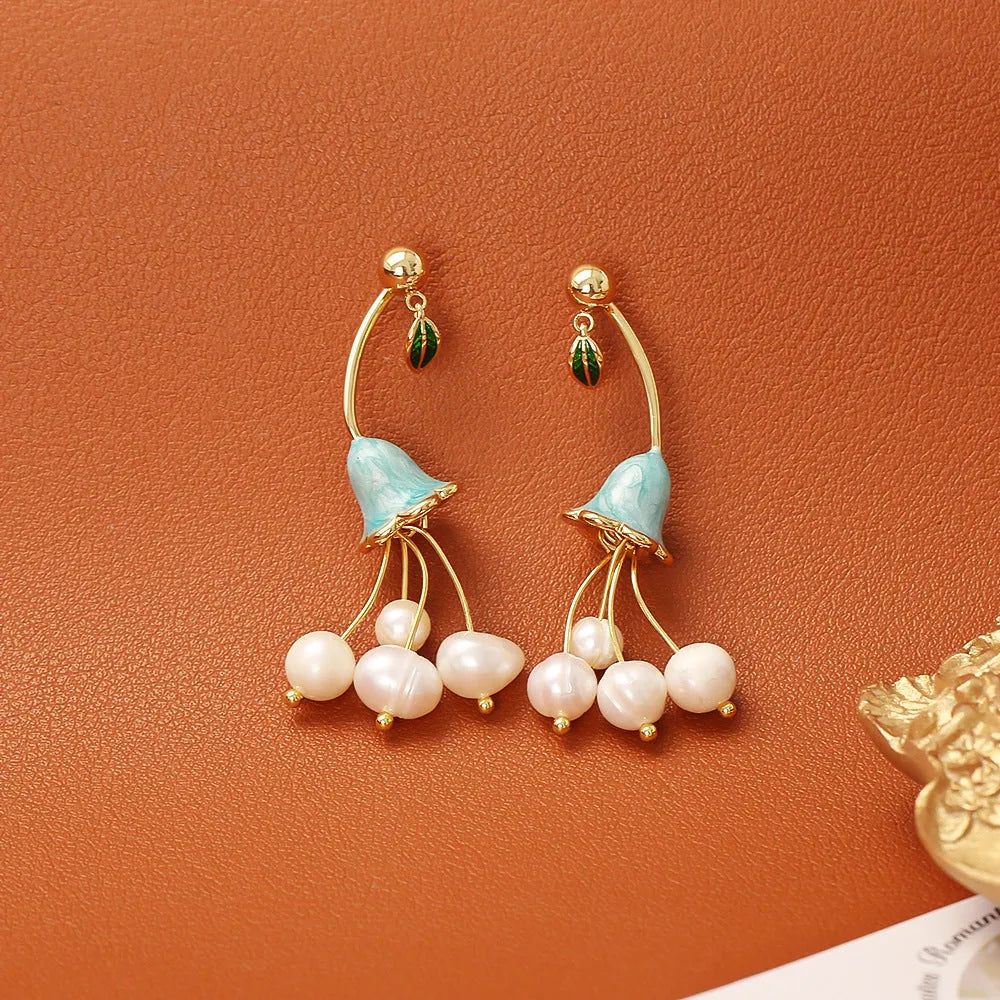 Natural baroque pearl ear studs in lily flower shape with gold plating on copper base