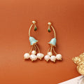 Natural baroque pearl ear studs in lily flower shape with gold plating on copper base