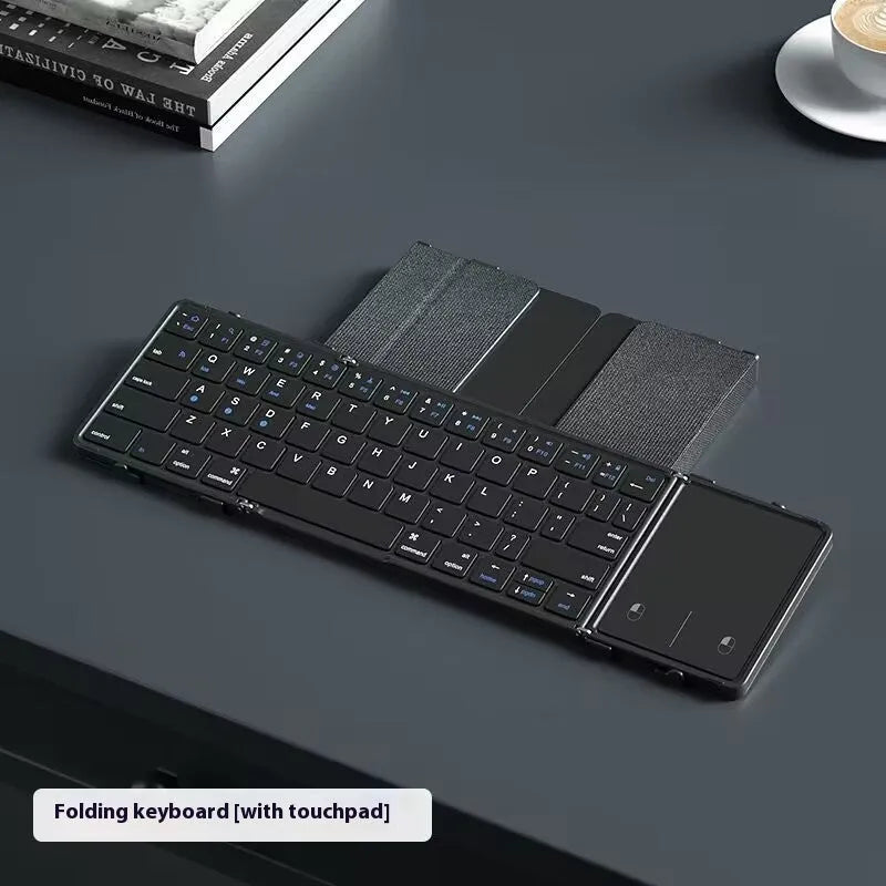 Black folding Bluetooth keyboard for mobile phones and tablets shown unfolded.