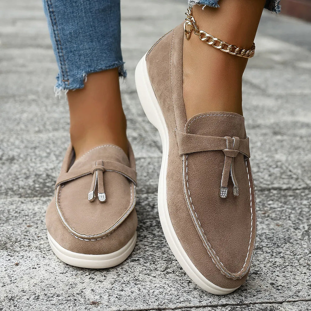 Casual canvas slip-on loafers with a platform heel and round toe in black, apricot, and brown colour options.