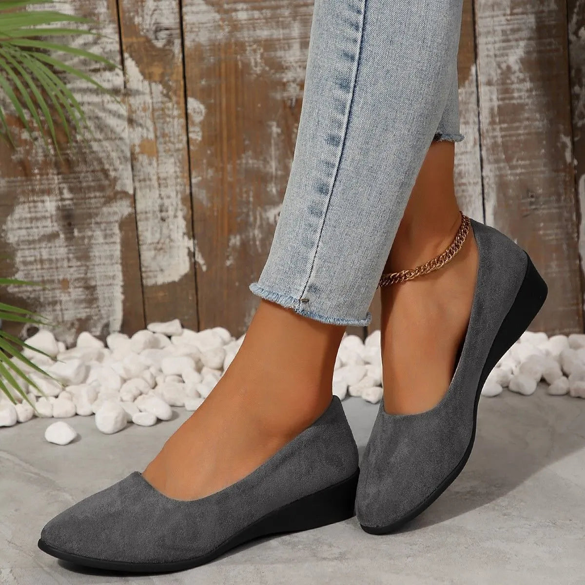 Women's pointed toe suede wedge pumps in light brown with a shallow mouth cut and low rubber sole.