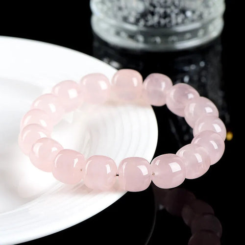 Pink bamboo crystal bracelet with 11-12mm barrel beads and geometric elements