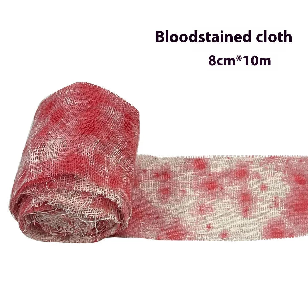 Roll of Halloween horror dyed gauze bandage in bloody red colour, shown with a loose end draped.