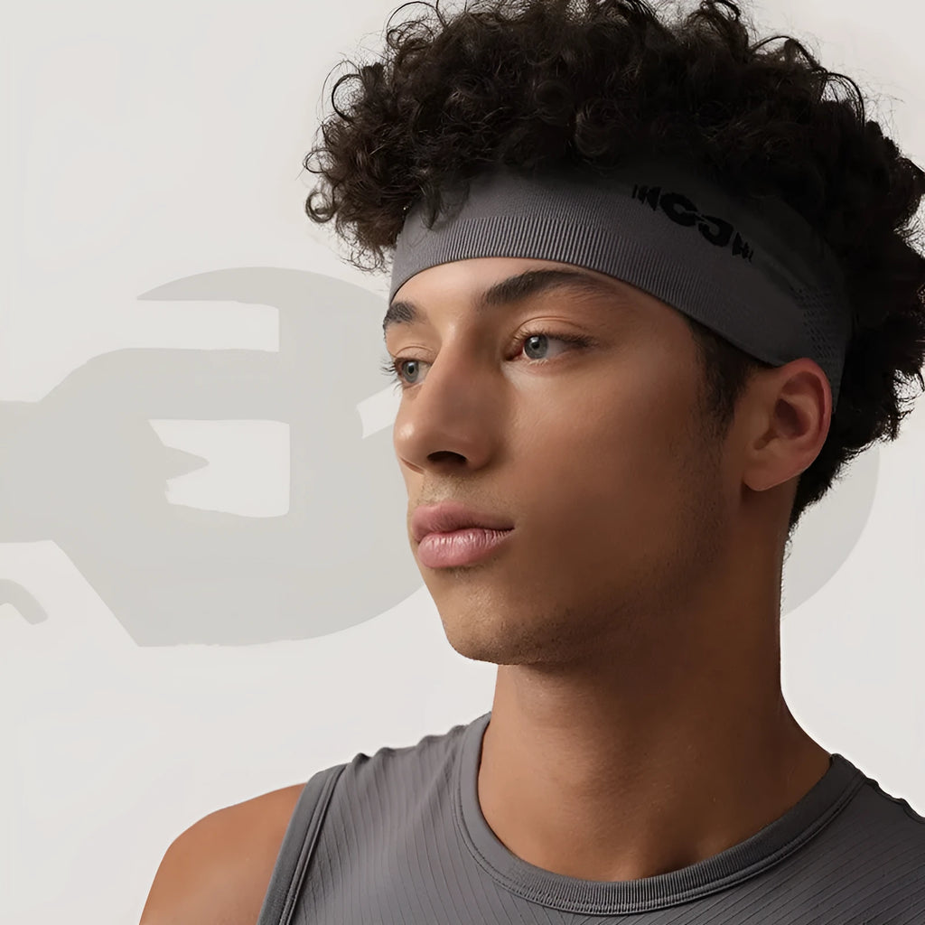 Classic black seamless knitted sports hair band for men and women on a white background.