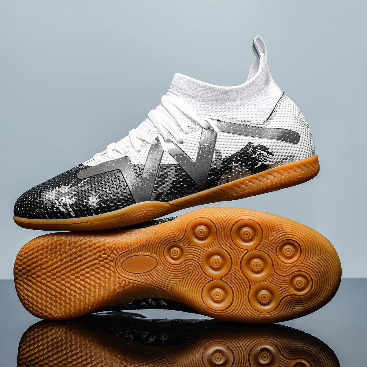 Adult football boots with replaceable studs in black and yellow colour with low-top mesh design