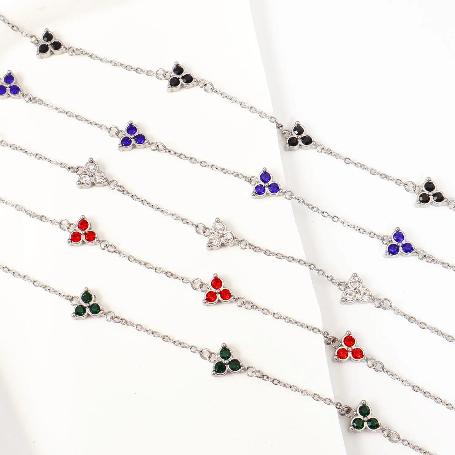Stainless steel women's bracelet with three triangular diamond motifs set with colourful zircon stones.