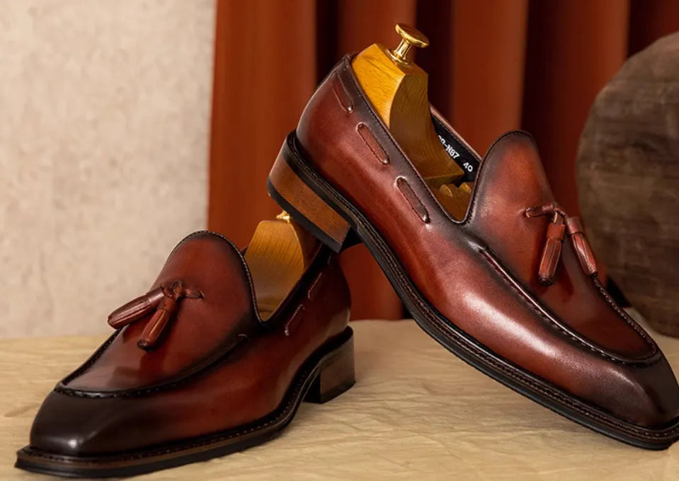 Men's black genuine leather slip-on loafers with fringed design and rubber sole