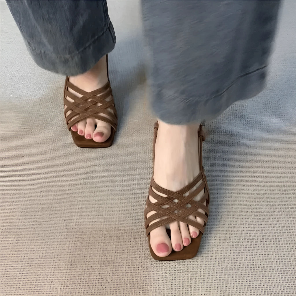 Women's light brown retro high heel sandals with thin cross straps and an ankle buckle on a square toe.