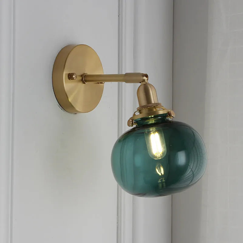 Pumpkin-shaped transparent glass wall lamp mounted on a wall