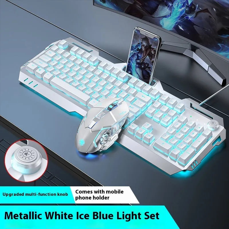 Aluminium gaming keyboard with volume knob, shown in metal grey with RGB lighting alongside optional macro mouse and headset.