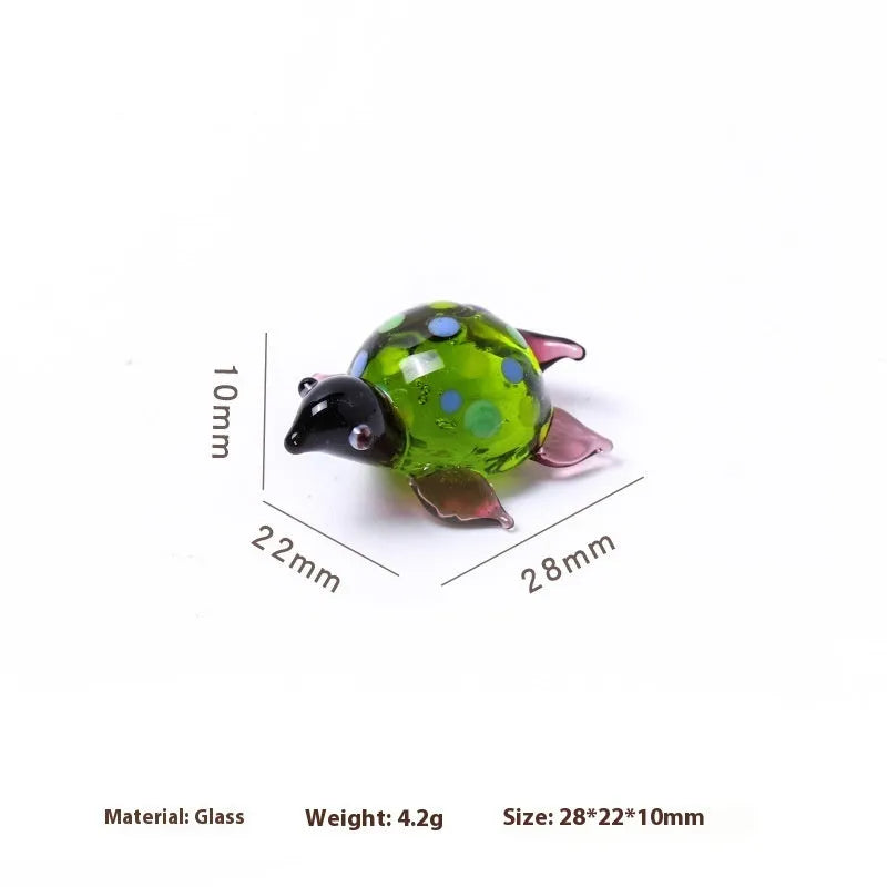 Geometric glass turtle desktop ornament in modern simplicity style on a wooden surface.