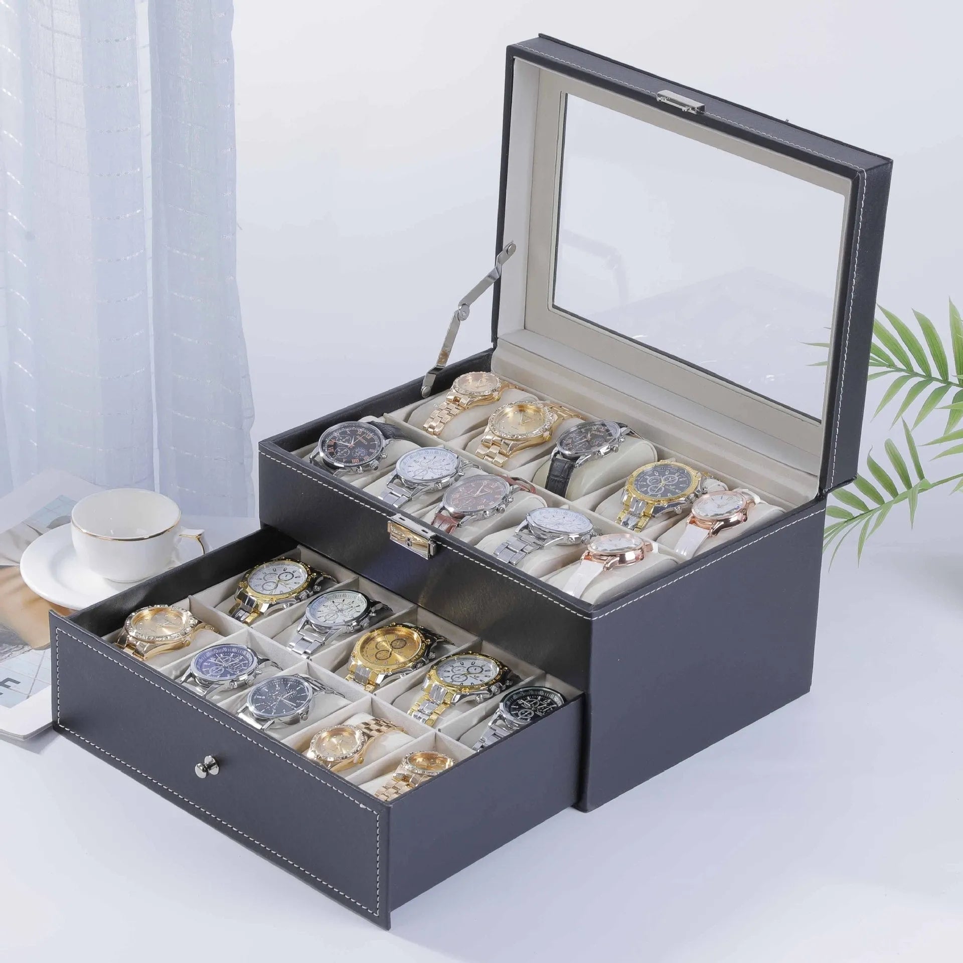 Grey leather watch storage box with clear lid showing watch compartments