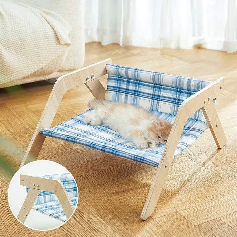 Wooden elevated cat bed with blue cloth cushion for indoor cats