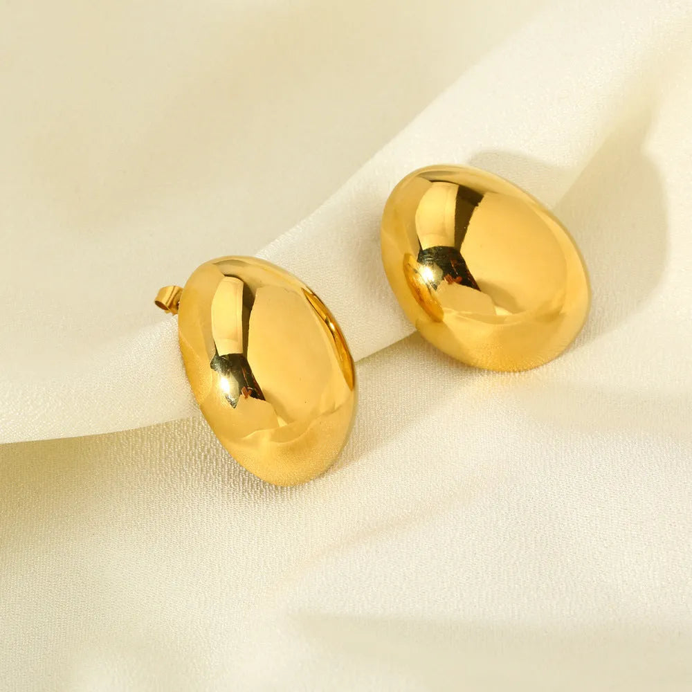 Close-up of simple geometric stainless steel stud earrings with 18K gold plated glazed finish and line design.