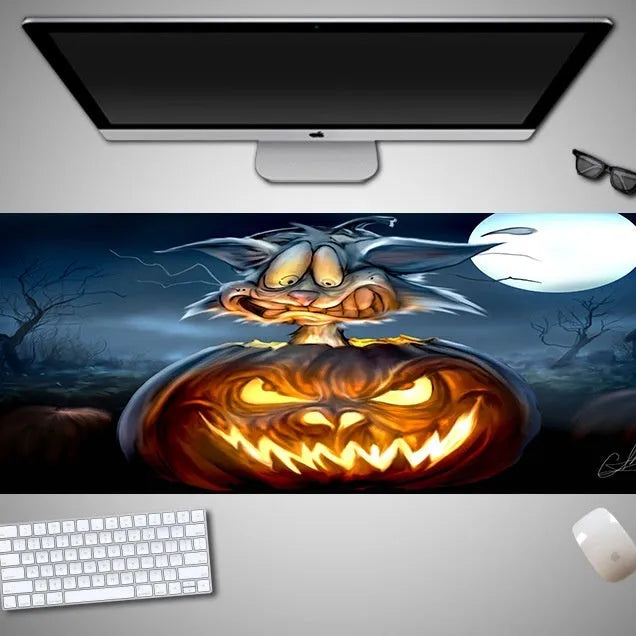 Large Halloween-themed computer mouse pad with graphic design on a desk