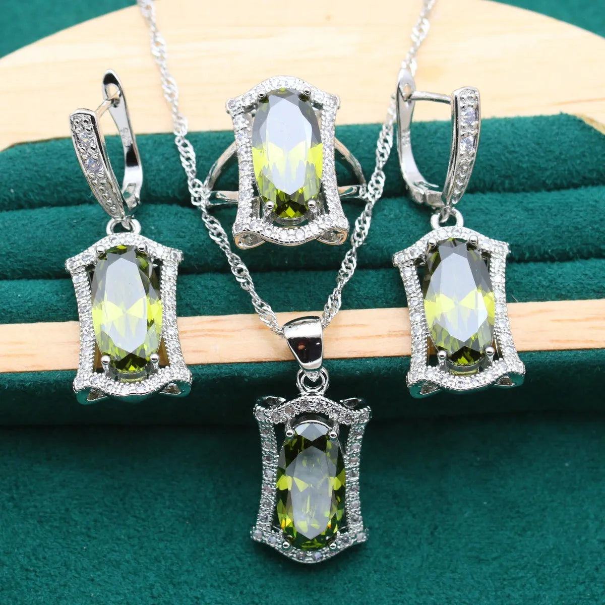 Yellow and olive anti-allergy alloy zircon jewellery set showing necklace, earrings, ring, and bracelet on a dark background.