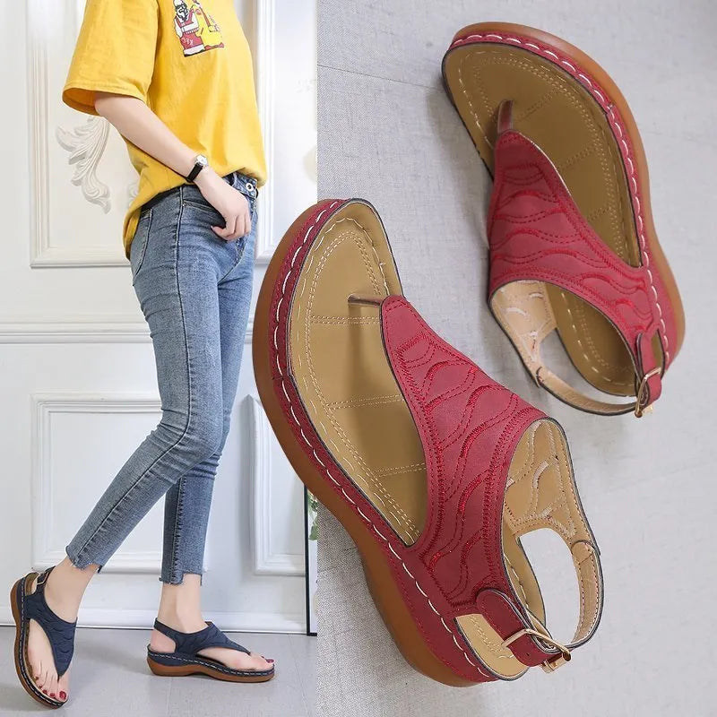Women's casual wedge heel flip flop sandals with an adjustable buckle strap in black.