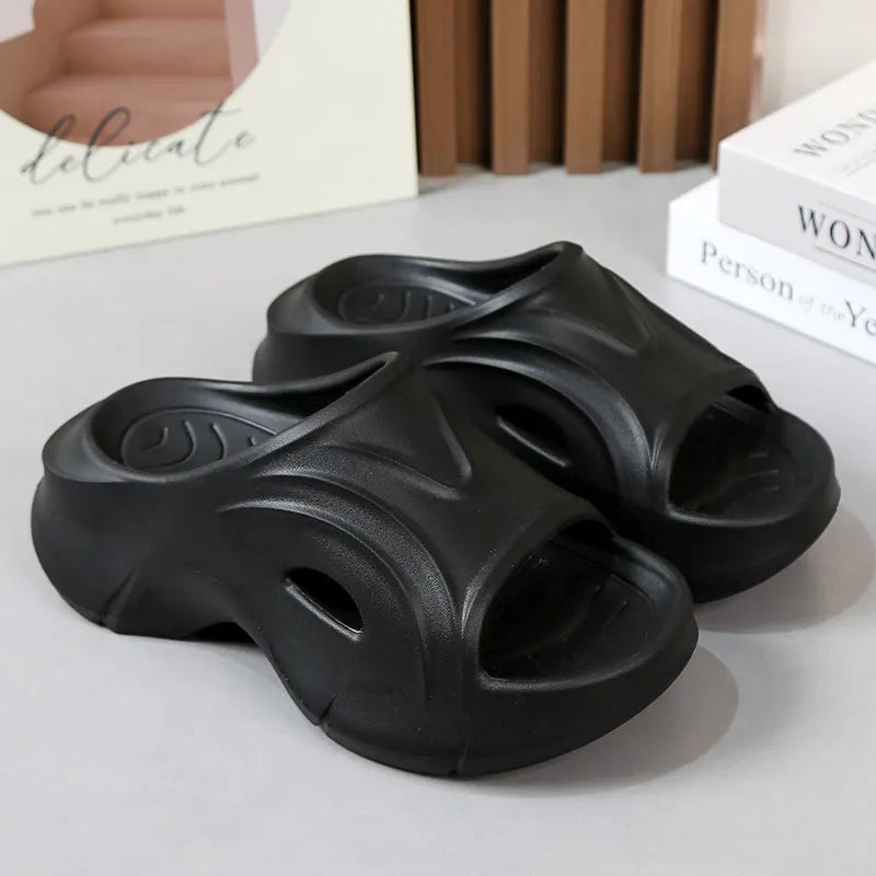 Women's thick-soled EVA slippers in rose red, shown on a beach background.