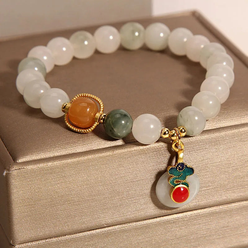 Women's ice jade crystal bracelet with pearl accents and a jade buckle on a white background.