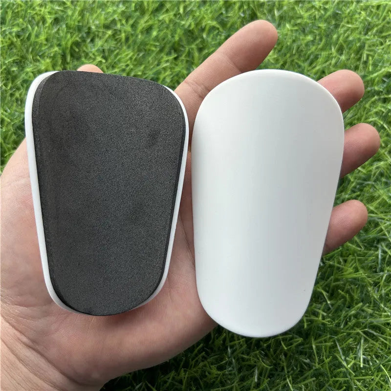 Extra small mini football shin guards plastic protection 8x5 cm black white youth