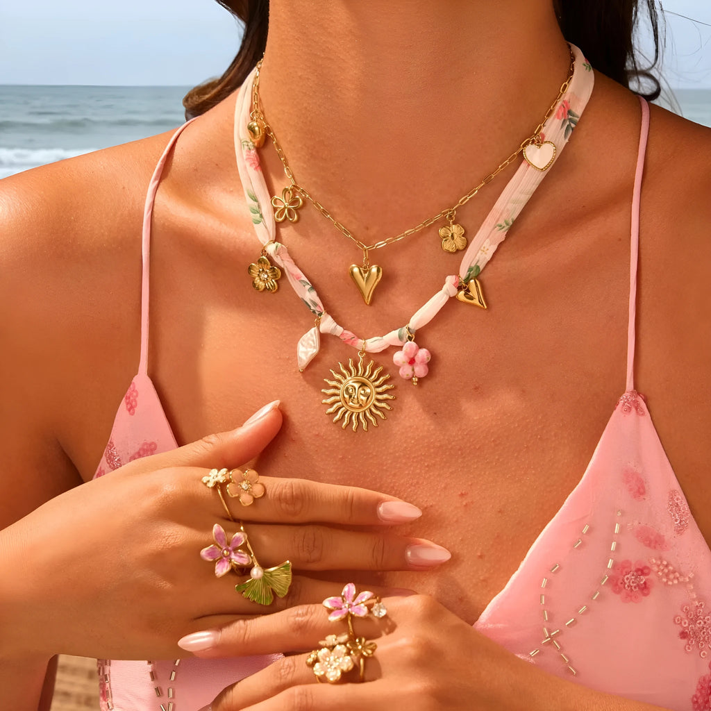 Geometric sun pendant on a stainless steel necklace with an 18K gold electroplated finish.