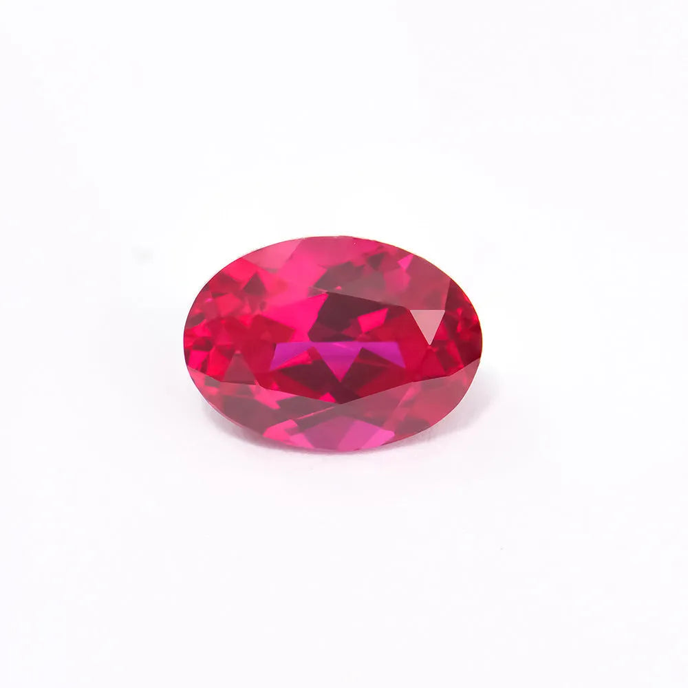 Cultivated pigeon blood red ruby gemstone in round cut on a white background.