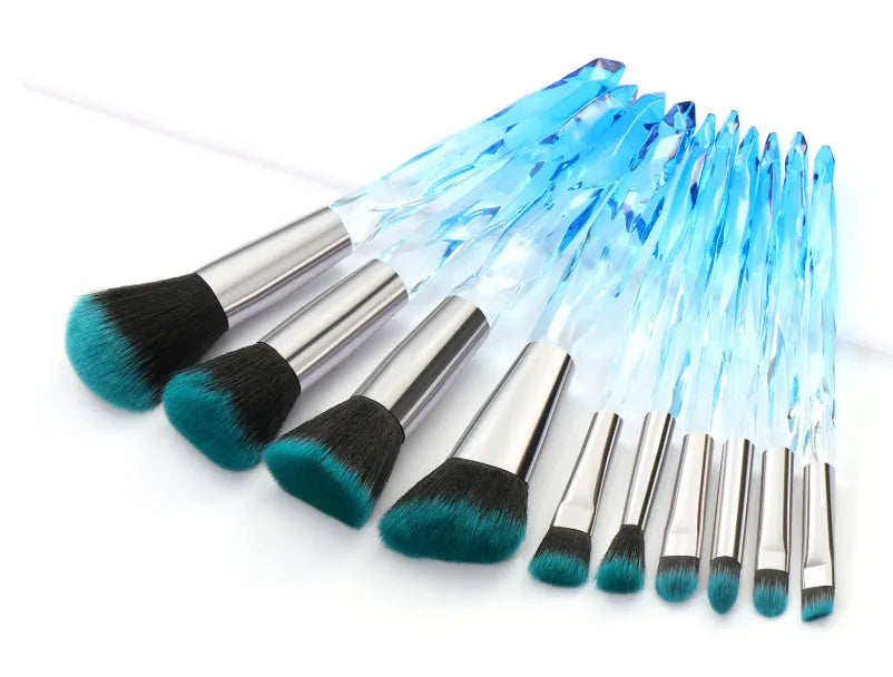 Ten crystal-handle foundation makeup brushes with synthetic bristles laid out flat