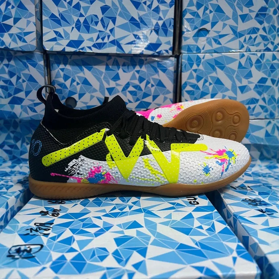 Adult football boots with replaceable studs in black and yellow colour with low-top mesh design