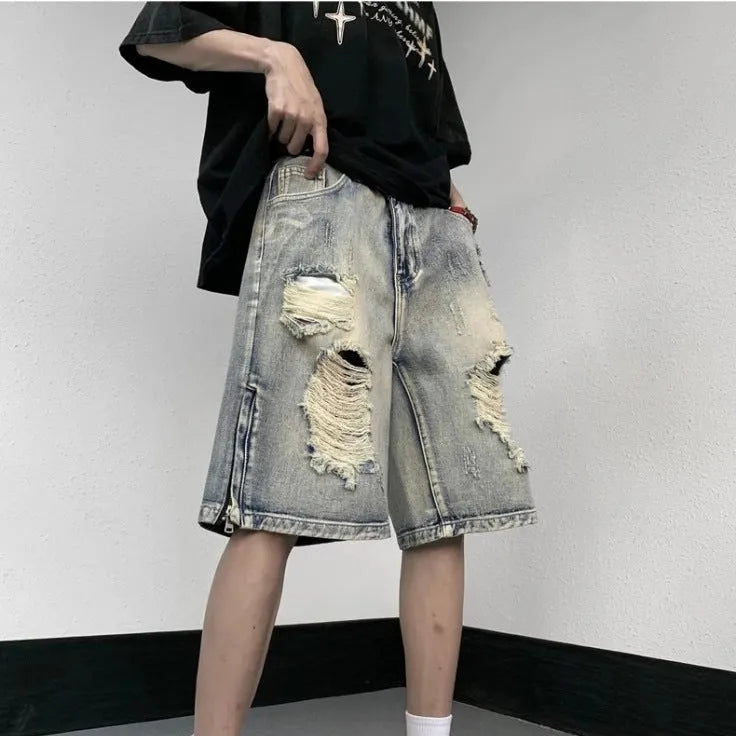 Blue retro-style denim shorts with a wide-leg loose fit and tattered details on a neutral background.