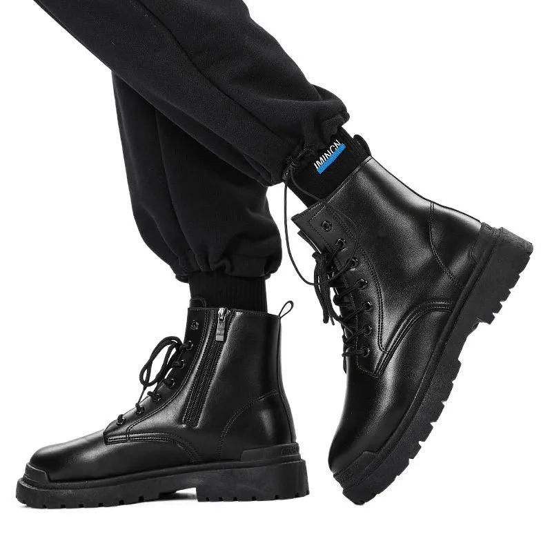 Men's black mid-top British leather boots with flat rubber sole on a neutral background